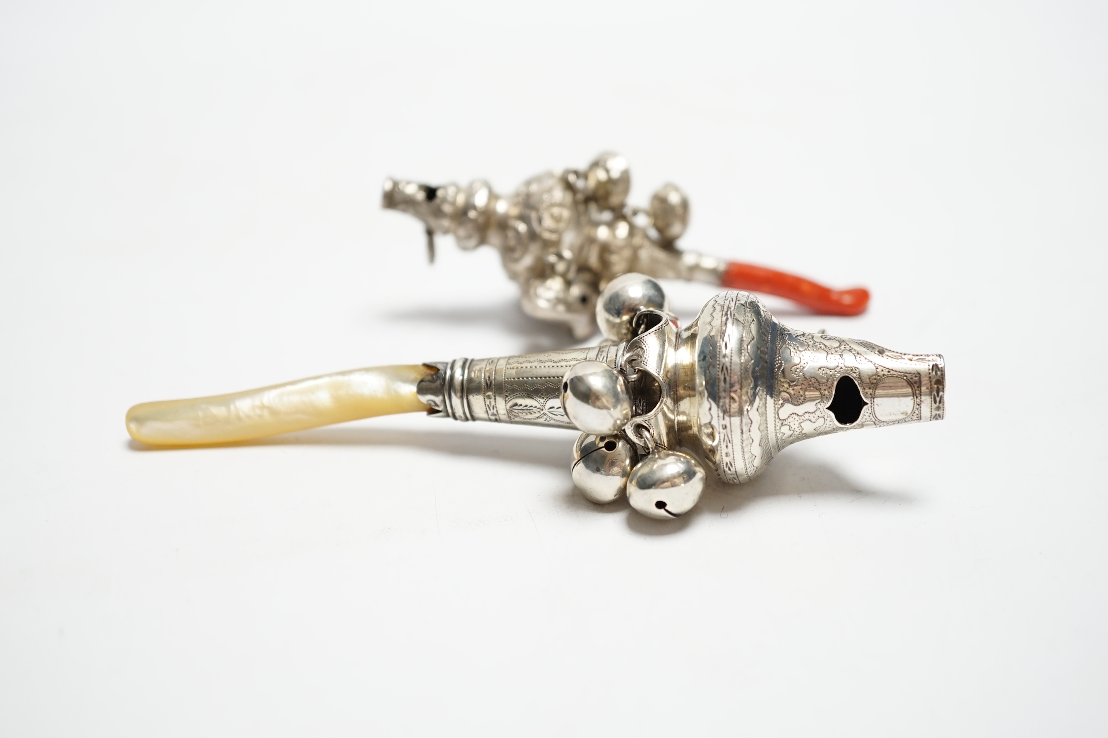 A George III child's silver rattle, with mother of pearl teether, Joseph Wilmore, Birmingham, 1808, 13.5cm and a late Victorian child's silver rattle, with coral teether.